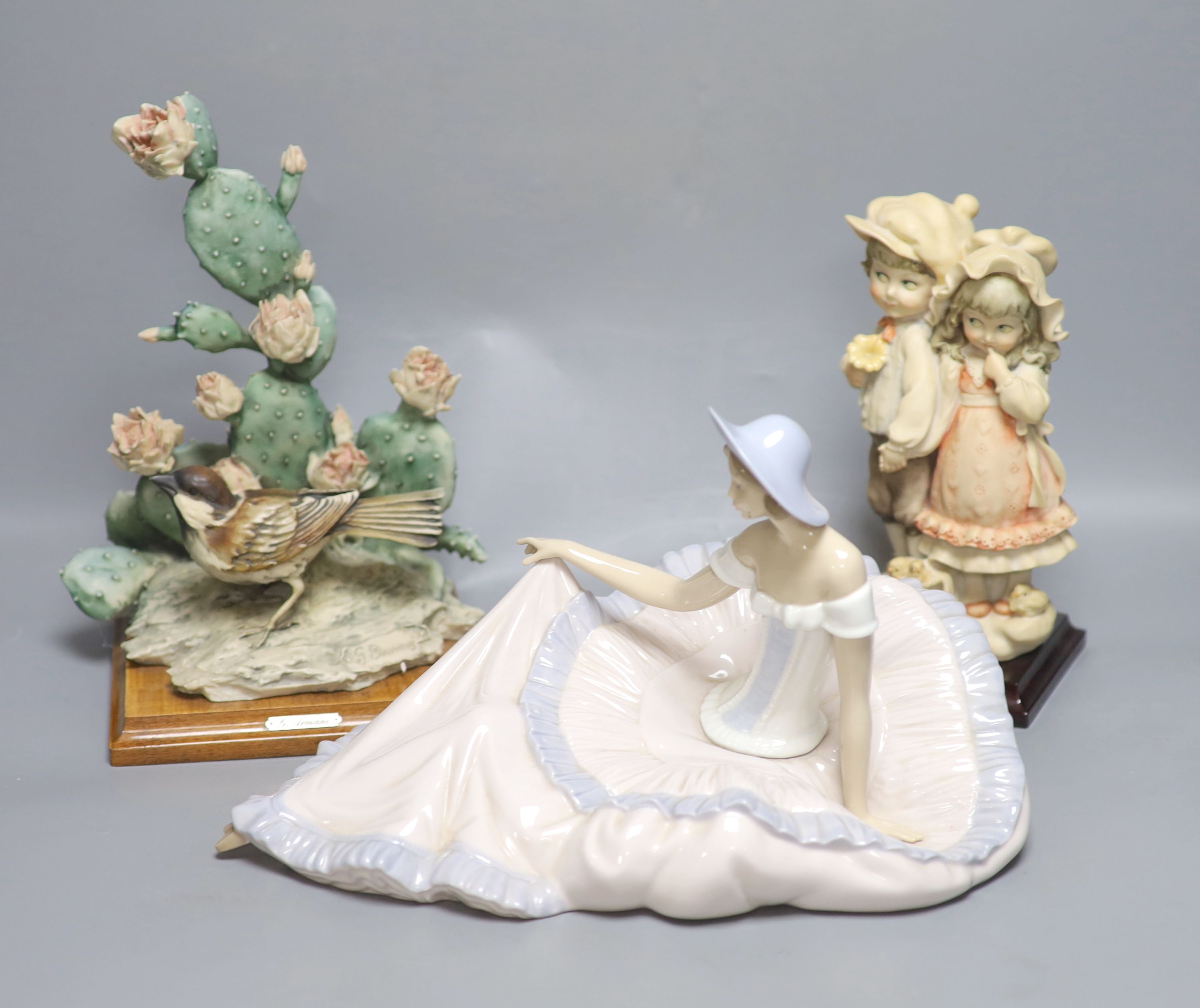 Two G Armani porcelain sculptures and a Nao figure of a lady